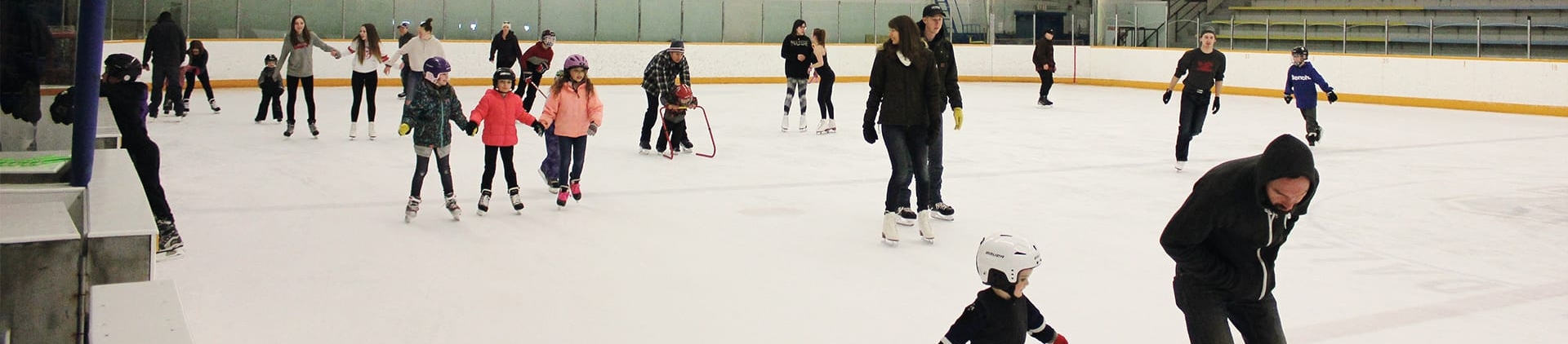 Children skating at indoor skating rink.